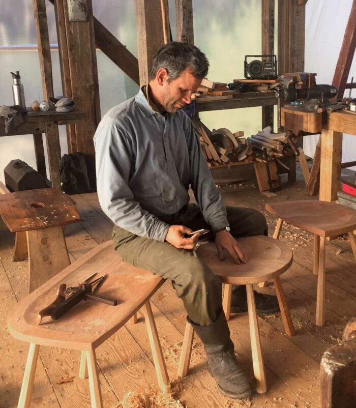 man working on wooden chair 