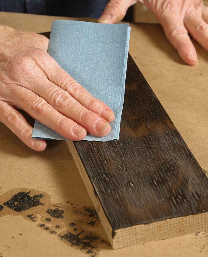 Scuff it up. The shellac will dry quickly, but you should still allow it to harden for a few hours. Scuff-sand the shellac with 320-grit paper and remove the dust with a clean cloth. 