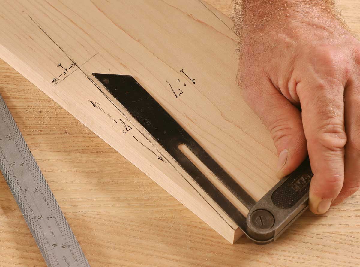 Simple setting. Strazza likes a 1:7 ratio for the angle of houndstooth dovetails, and a quick drawing on a scrap guides the setup of his sliding bevel.