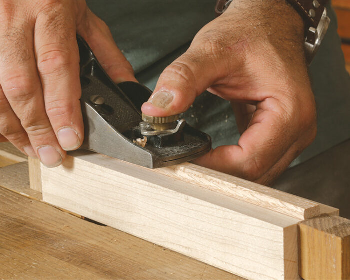 Planing a tapered flat along an oak dowel while testing it frequently