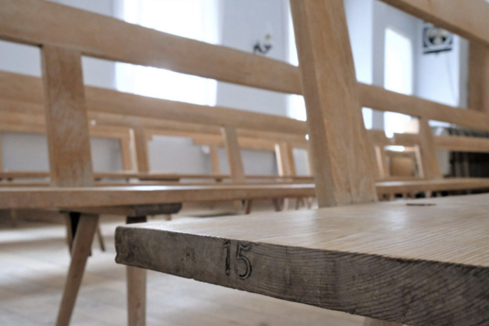 An Amana Church Bench with the number "15" marked on the end