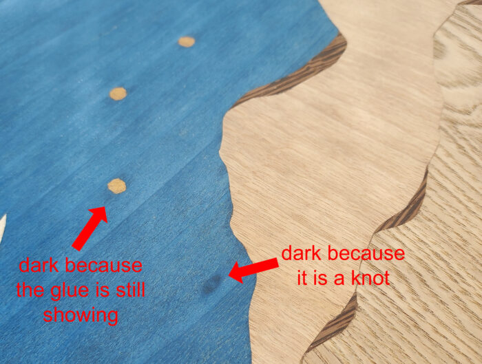 Differentiating between knots and dark spots from glue in veneer
