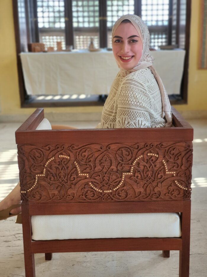 Mirna ElTatawy sits in her hand carved chair
