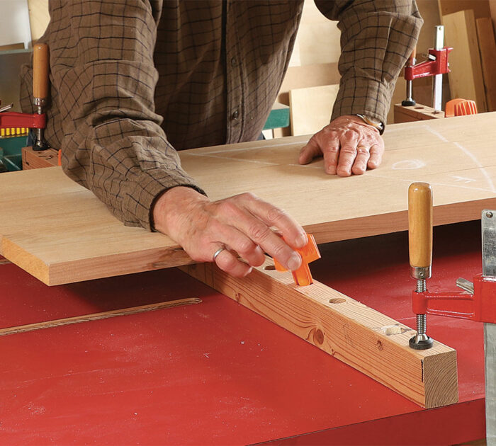 McIvor lays his panel boards in place to rough out their spacing, then presses in the saddle inserts