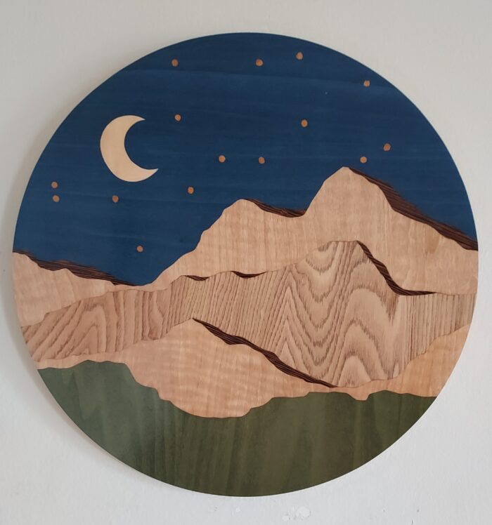 Chelsea Van Voorhis' finished work of veneer art depicting a night scene with mountains.