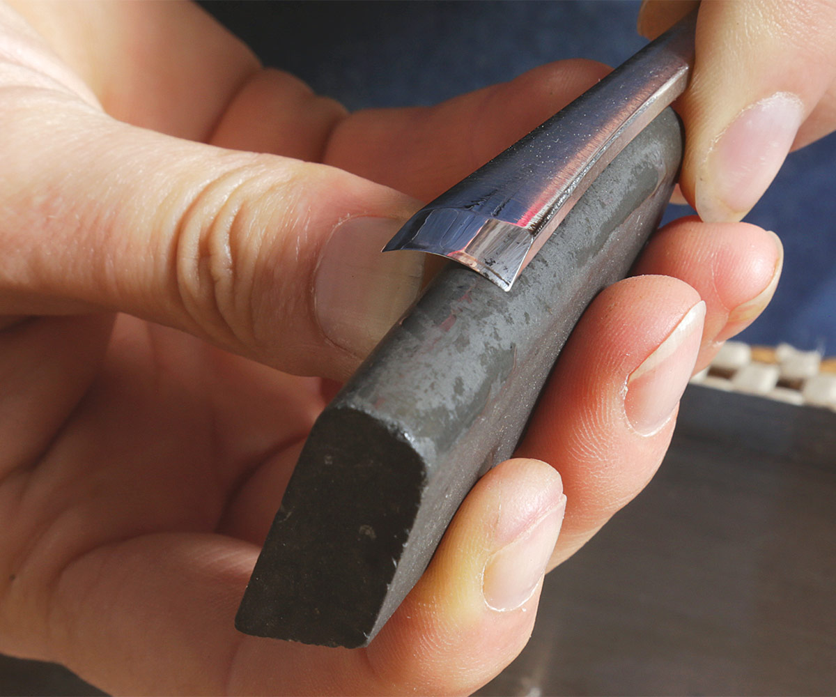 sharpening a gouge with a curved slip stone