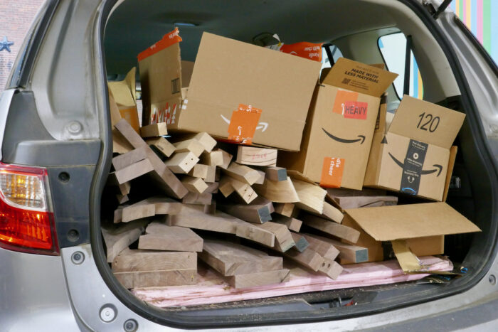 A collection of unique scrap wood packed into the trunk of a van
