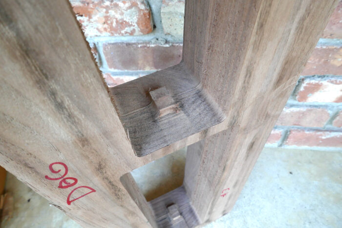 Laminated blocks of scrap wood with a trapezoid-shaped hole reminiscent of cinder blocks
