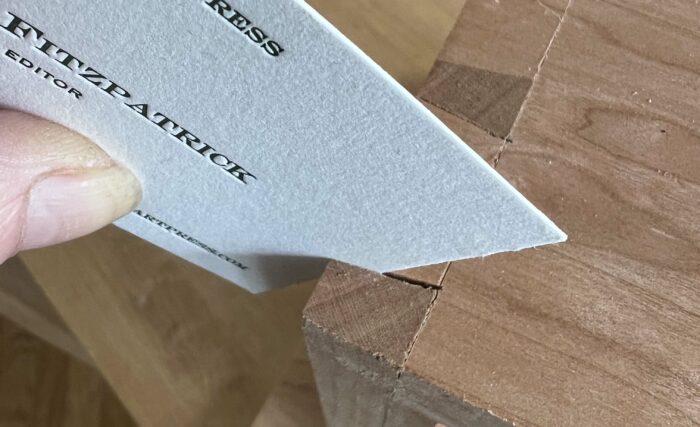 Megan Fitzpatrick wedges a business card in a gapped dovetail