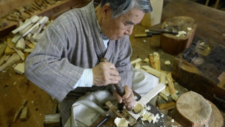 An 87-year-old man carves a traditional Japanese ladle