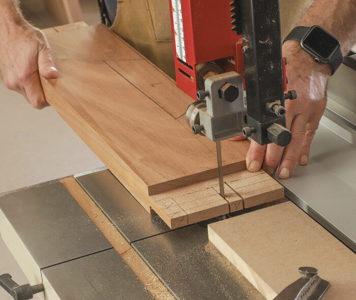 The twin tenons. After creating a tenon the full width of the lower rail with a dado stack on the table saw, Hartman here uses a low fence and a stop at the bandsaw to notch out the waste between the tenons and at the haunch.