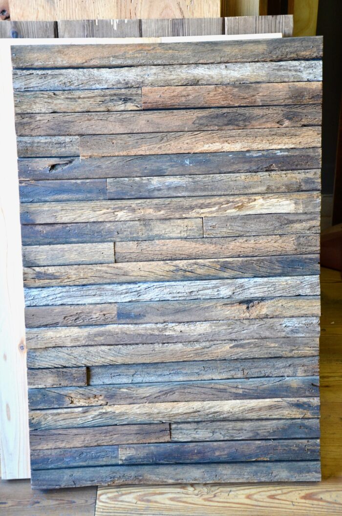 A wooden canvas made from a basic reclaimed wood quilt, also known as a wood tapestry.