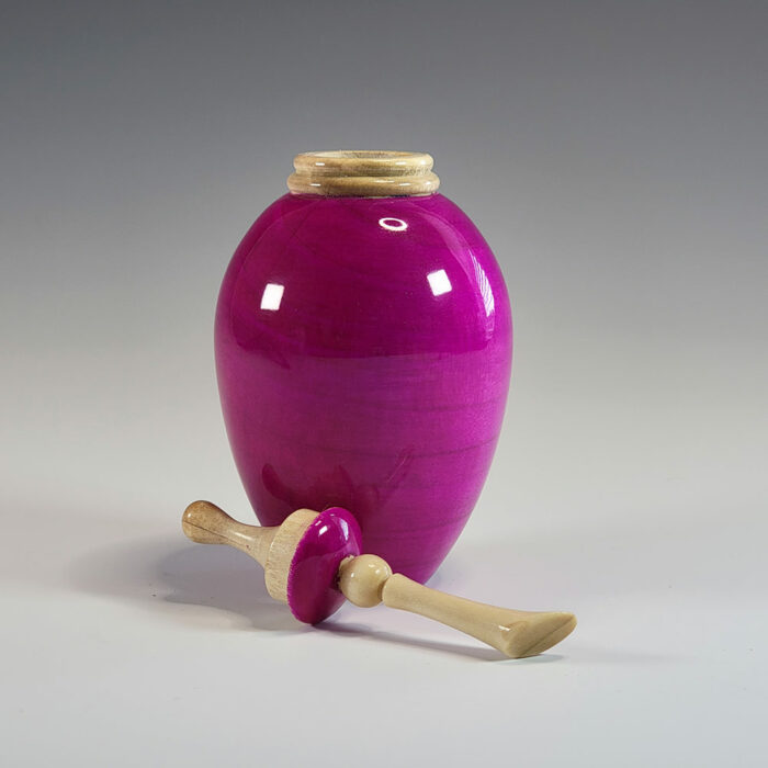 A purple painted wood turned vase with a smooth glass finish