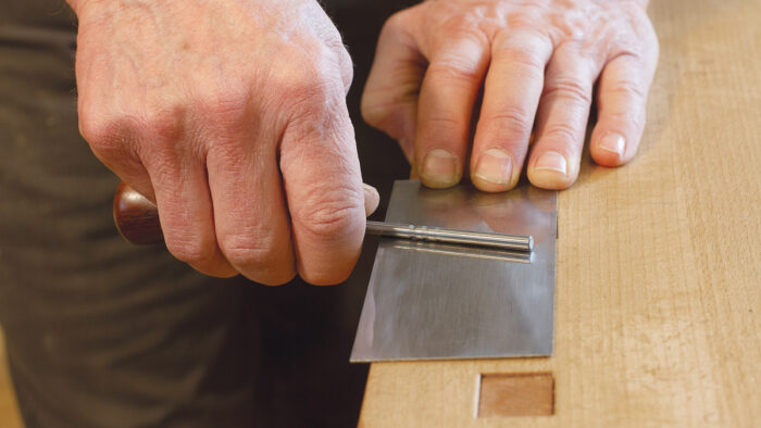 Leaving one handle off lets you lay it flat to pull burrs upward, a key part of the burnishing process.