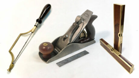 Handmade tools from left to right: mini frame saw, Stanley no. 1 cast bronze handplane replica, and brass bound wooden levels