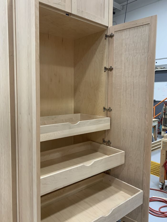 An open cabinet showing a nicely outfitted interior. 