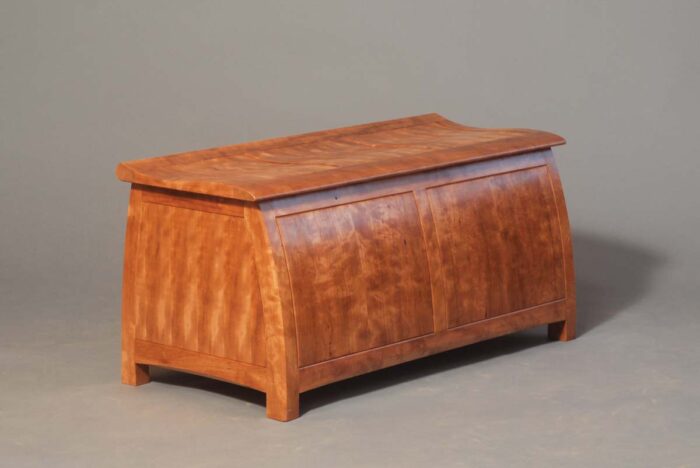 A blanket chest where every single surface is delicately curved as opposed to flat surfaces you're likely to see. 