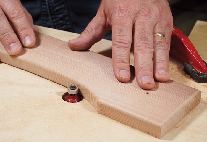 Asa uses a round over bit with a bearing to shape the cedar. 
