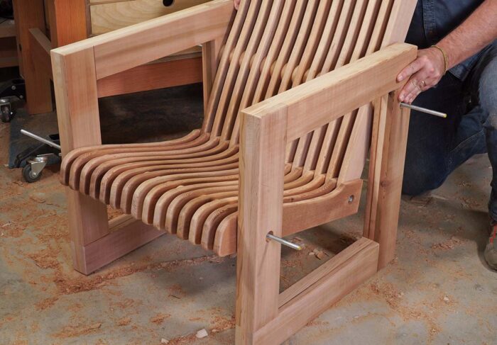 Asa assembles all the chair slats with a threaded rod. Rod is exposed on either side of the chair. 