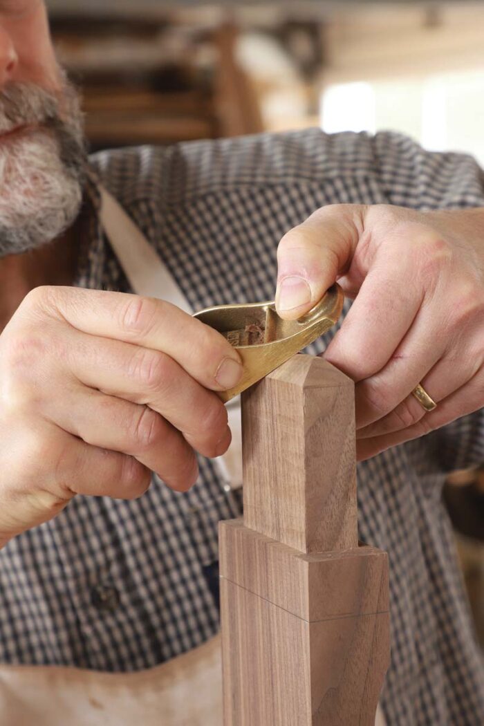 Tom uses a block plane to heavily chamfer all edges of the tenon. 
