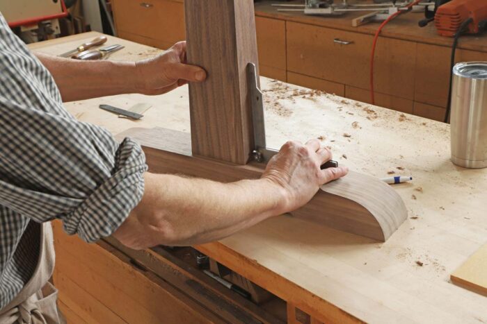 Tom uses a bevel gauge to measure the angle where the foot meets the leg. 