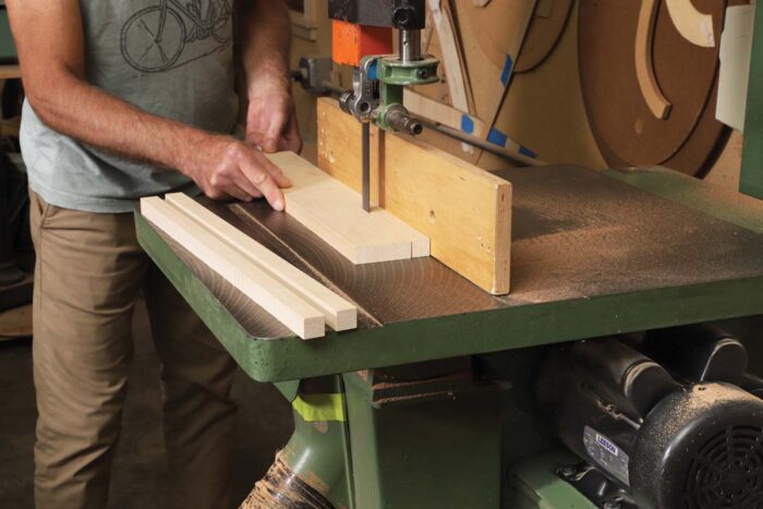 Tim Coleman rips a board of basswood into staves on the bandsaw. 