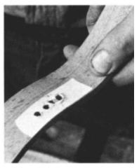 Jerry shows the holes hes drilled for the mortise, covered by tape to prevent blowout.