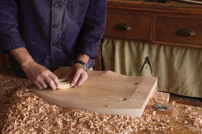 A travisher is being used on the seat blank to carve out the seat. 