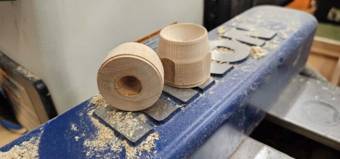 Two pieces of wood sitting on the lathe.
