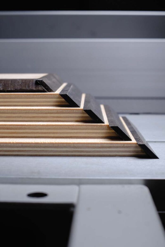 A stack of veneered and edge banded baltic birch sits in a pile. 