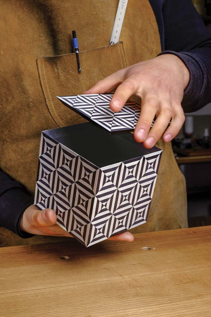 Vasko holds his completed box, with the lid lifted slightly. 