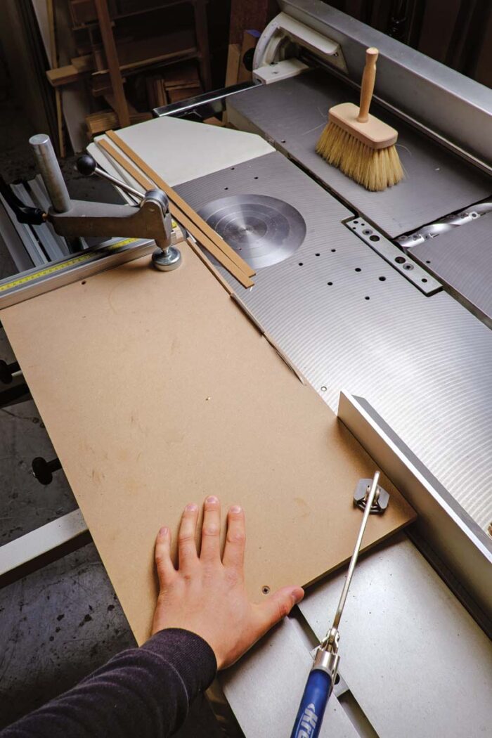 Vasko rips strips from a sandwich of MDF and commercial veneer to make the even strips to begin the parquetry pattern. 