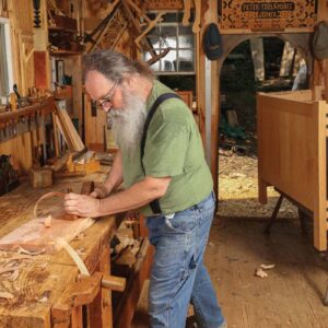 Planing the board with a wooden scrub plane